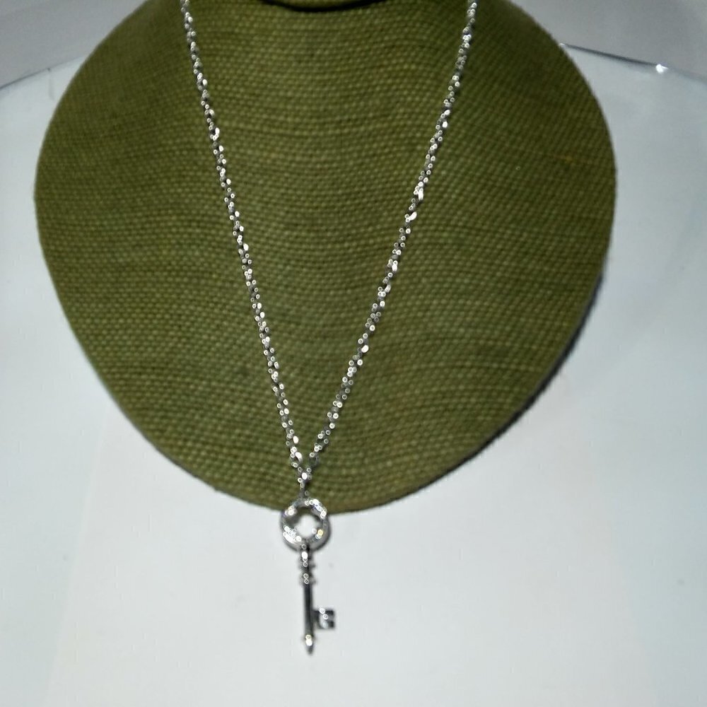 Women`s silver tone crystal key necklace.
